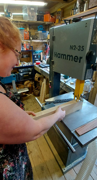 Cutting timber on machinery at Thompsons Wood